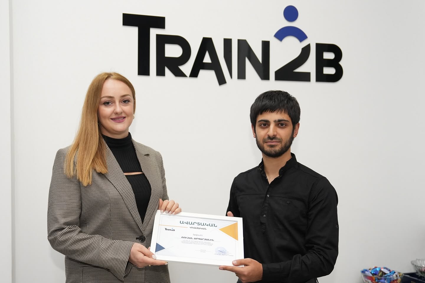 Student receiving training certificate at Train2b