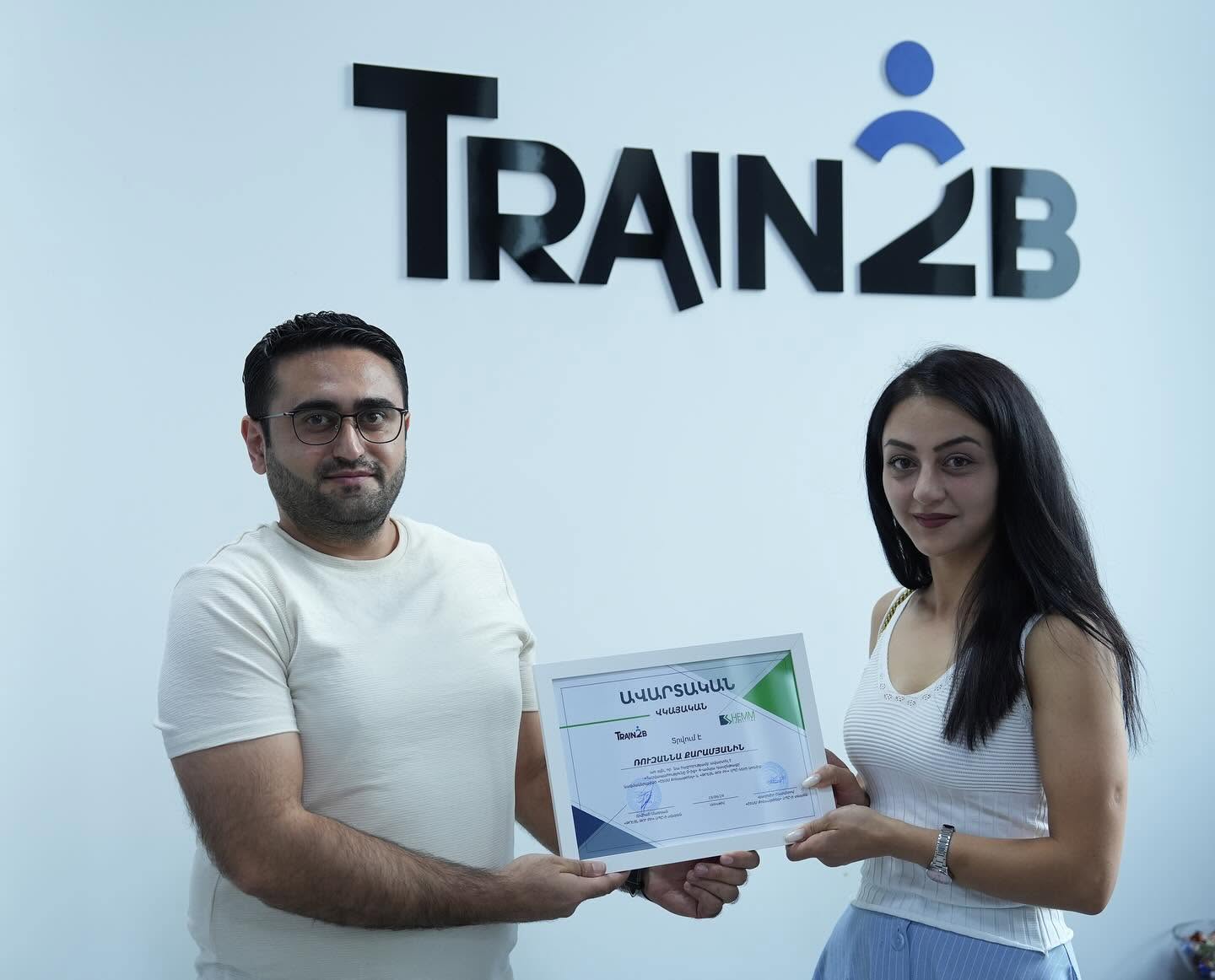 Certificate presentation to graduate at Train2b