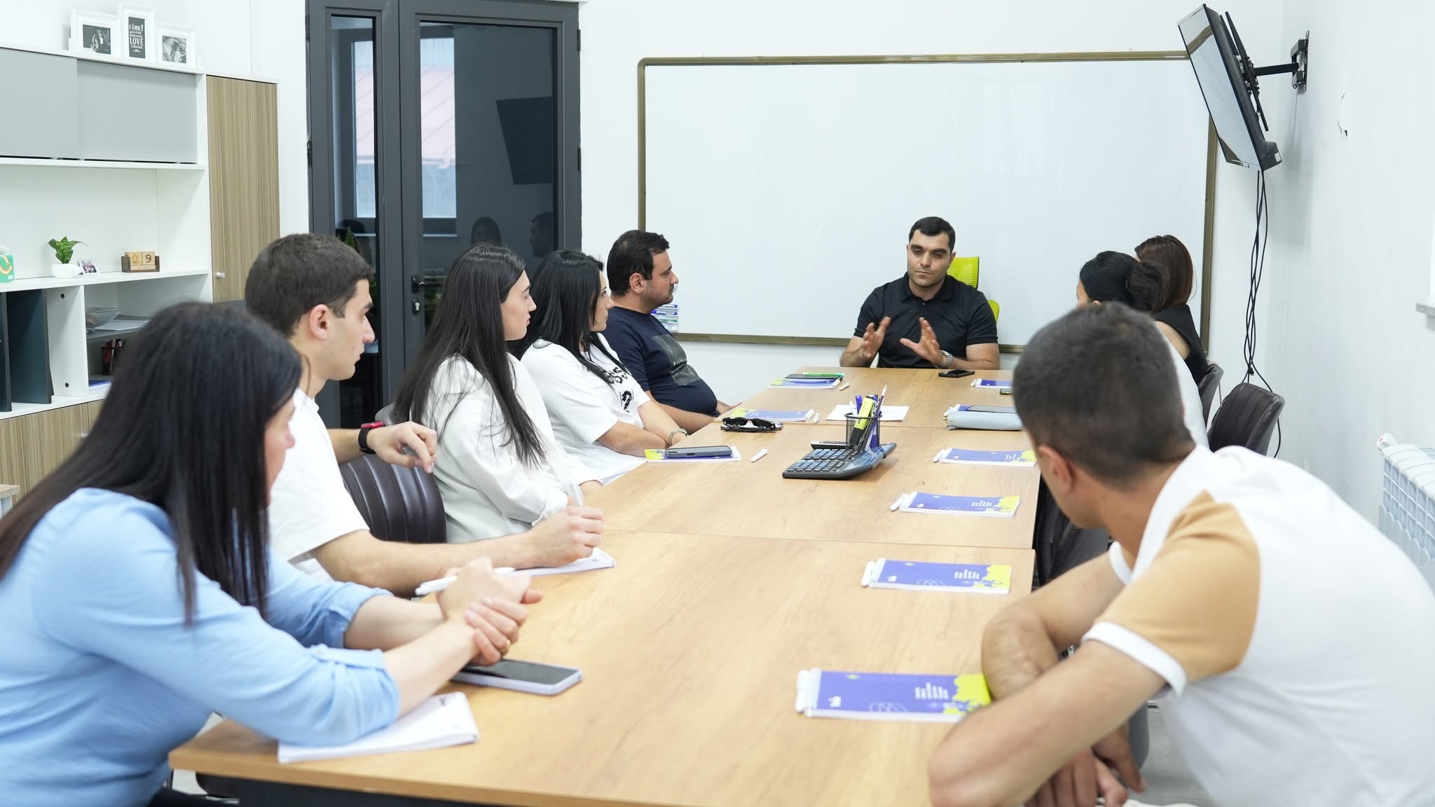 A Train2b instructor teaching a group of adult students in a classroom setting