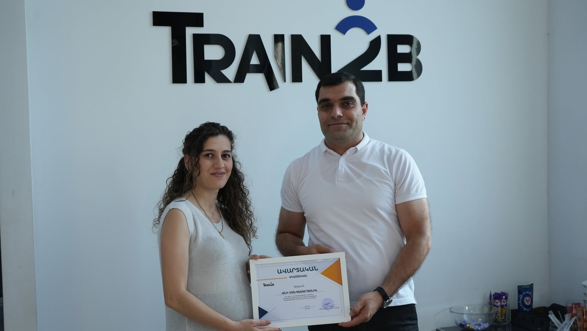Graduate celebration with certificate at Train2b